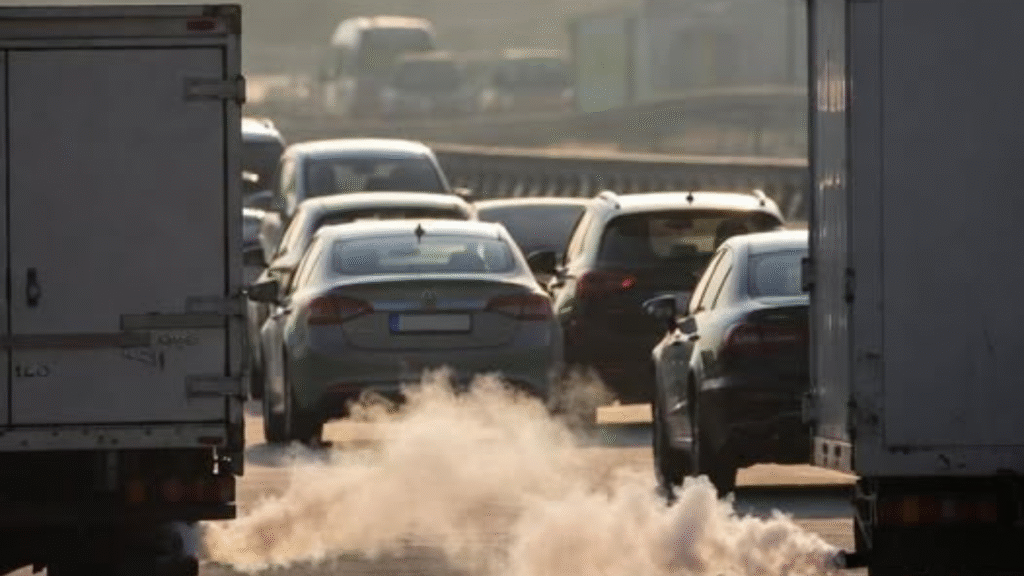 Delhi skyline in thick smog with electric auto in foreground