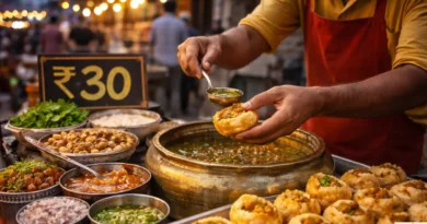 Indian street food vendor preparing golgappa at roadside stall with ₹30 price board in background