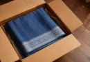 blue cotton saree neatly folded inside courier box first salary gift
