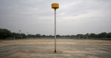 Empty korfball post on a quiet outdoor ground under an overcast sky in India