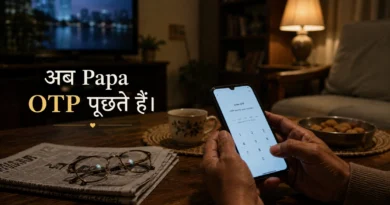 Older Indian father holding smartphone in living room during evening