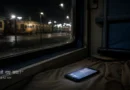 Train window at night with unread phone messages visible