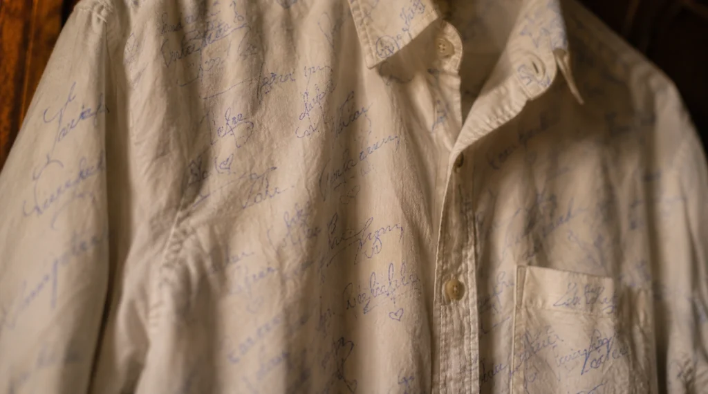 Close-up of faded signatures on old white farewell shirt
