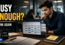 Busy vs Productive at Work in a modern office professional reviewing a packed calendar.
