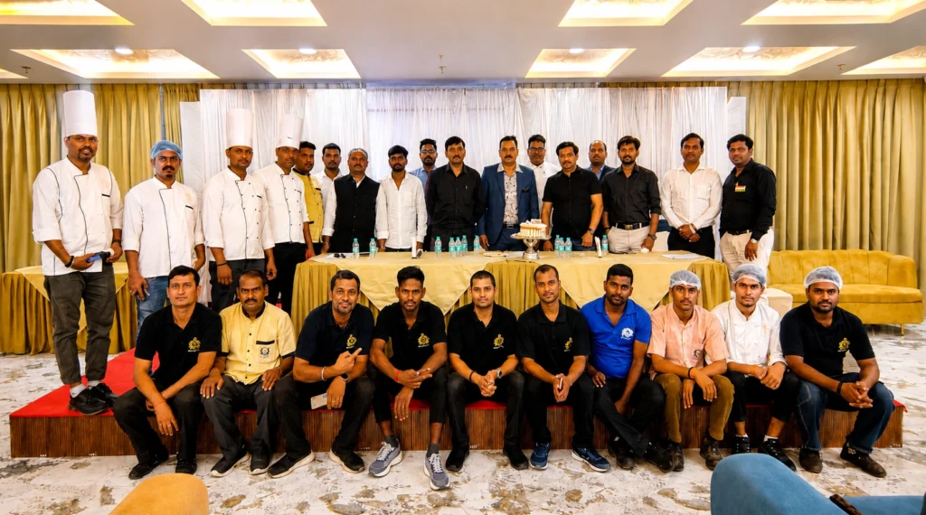 Hotel staff and team members posing together at an indoor event